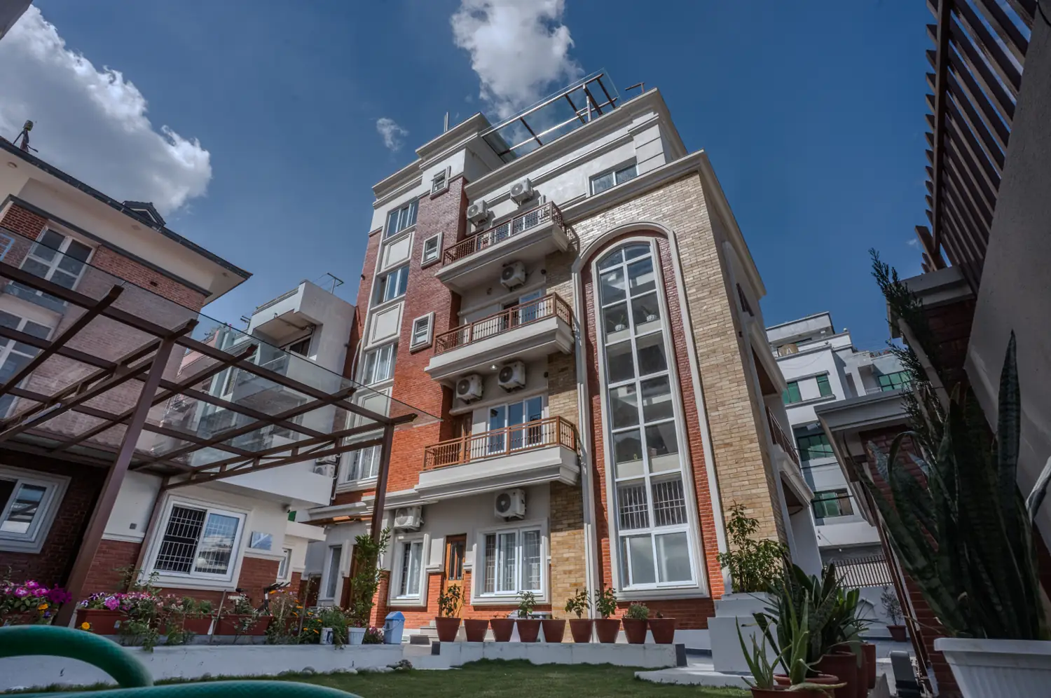 Red-brick building with an arched glass stair tower