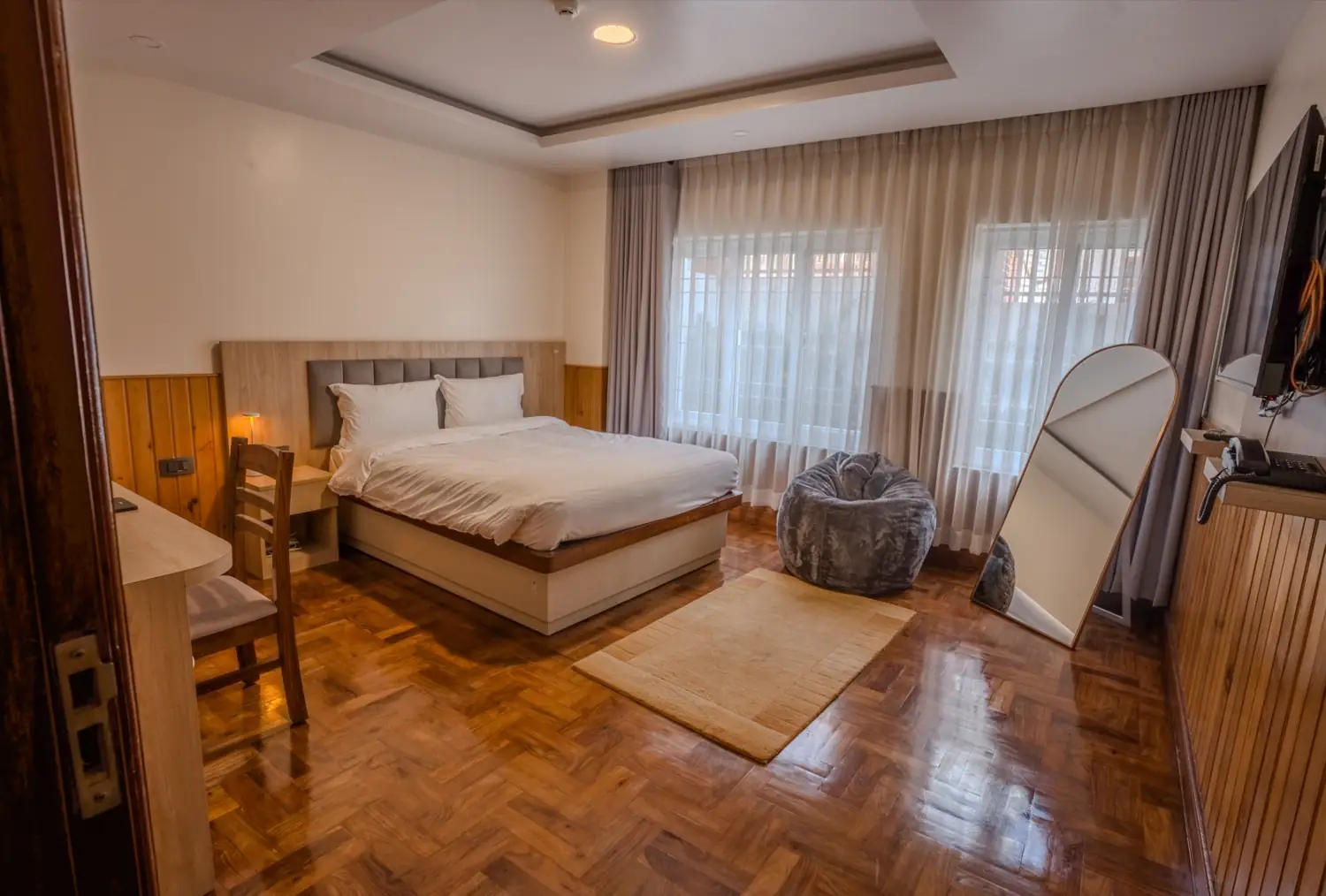 Bedroom with parquet floor and soft light